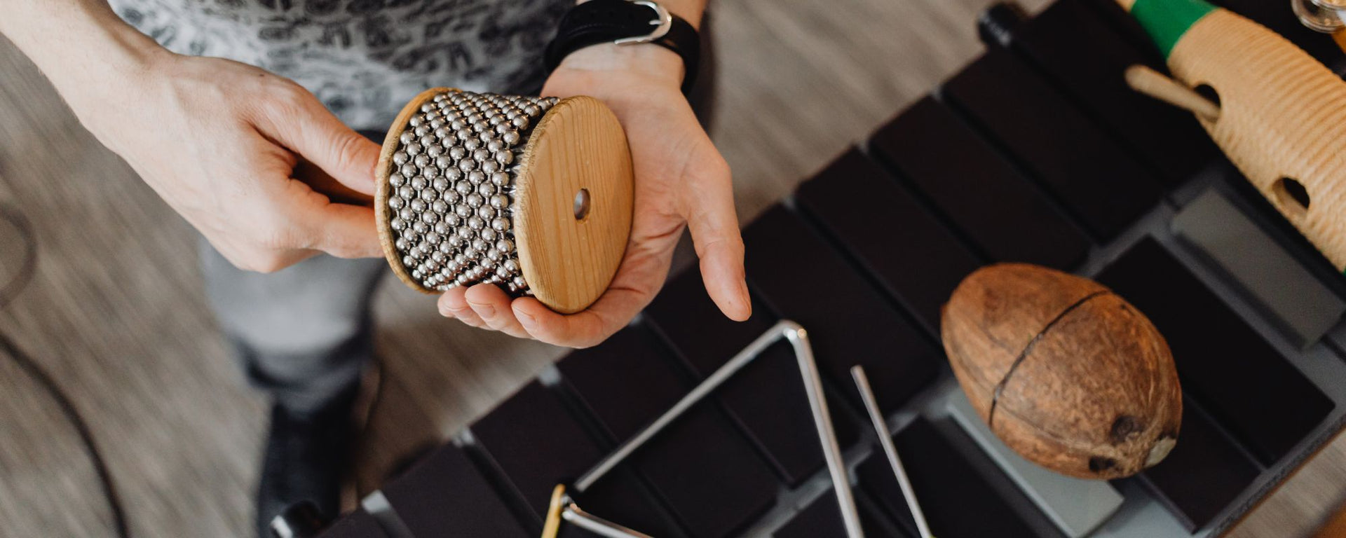 Cabasa player with various percussion instruments.