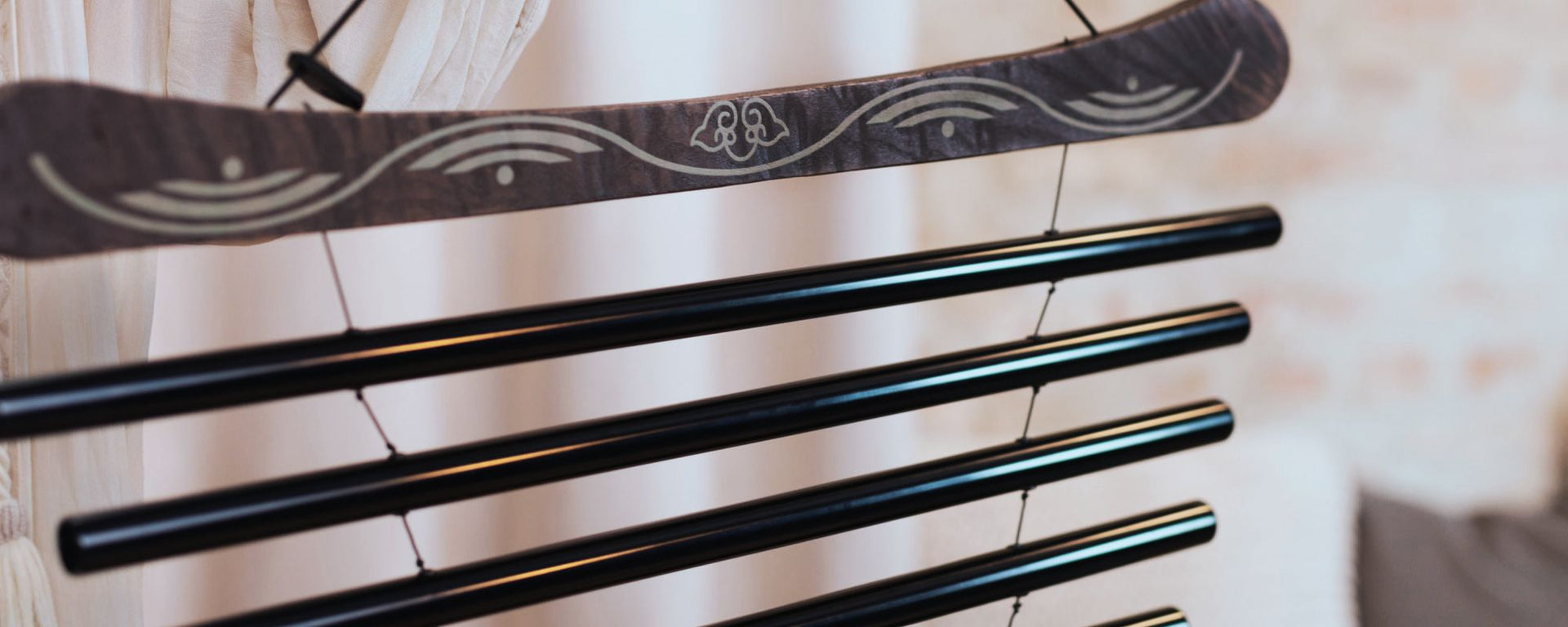 Woman holding a meditation flow chime with mallet during a calming sound healing meditation session.