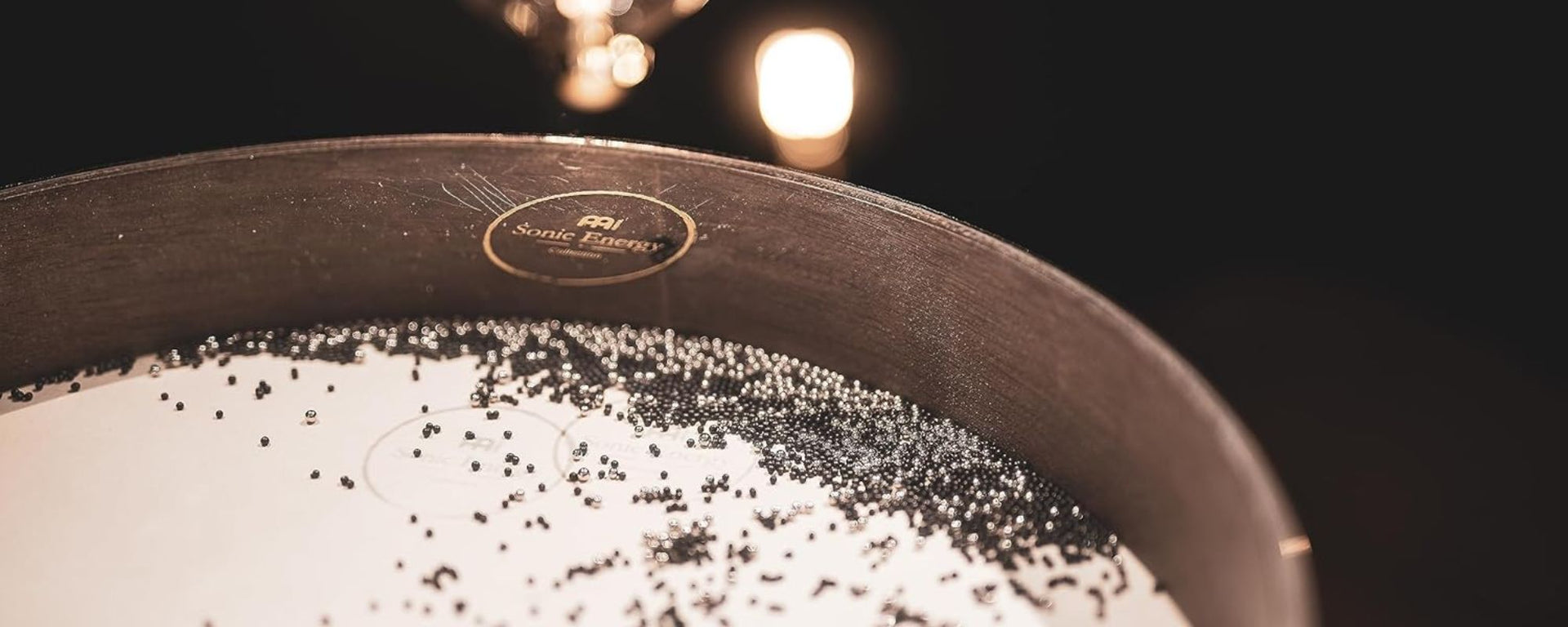 Close-up of an ocean wave drum against a dark background, designed to produce soothing, calming tones for meditation and sound healing sessions.