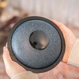 Person showing the bottom of the Meinl Sonic Energy Mini Steel Tongue Drum.