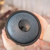 Person showing the bottom of the Meinl Sonic Energy Mini Steel Tongue Drum.