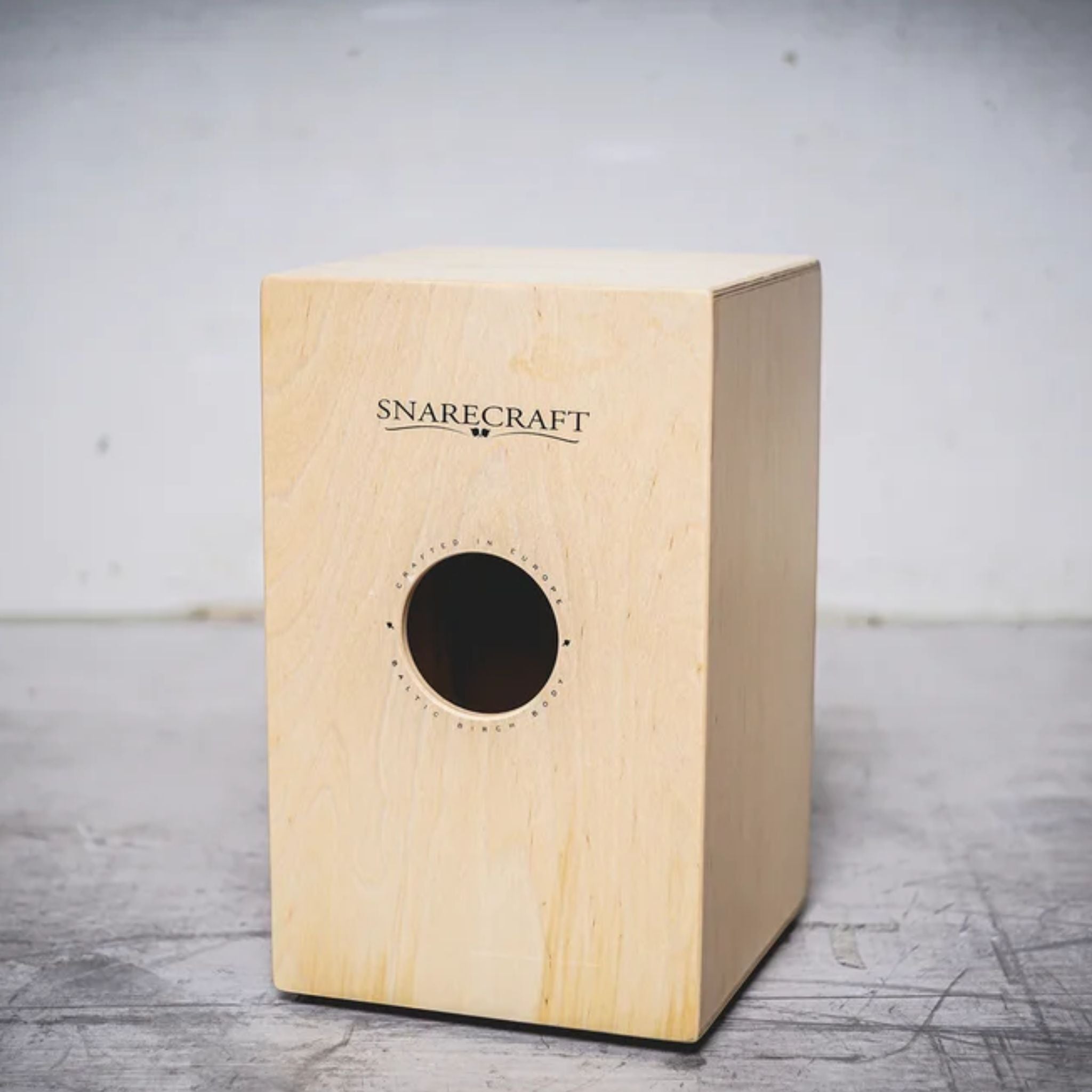Rear view of the Meinl Snarecraft Cajon with sound port and natural wood finish.