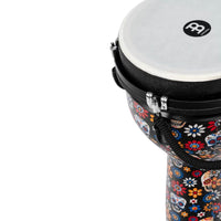 Close-up of the Meinl Jumbo Series Djembe Drum 10" Day of the Dead JD10DA showing the synthetic head, shell artwork and mechanical tuning hardware.
