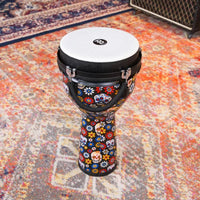 Meinl Jumbo Series Djembe Drum 10" Day of the Dead JD10DA displayed on a patterned rug in a music studio setting.