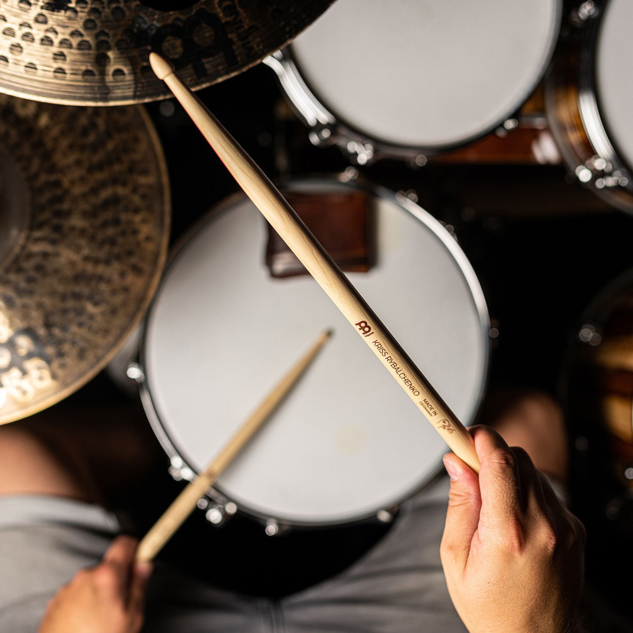 Drummer playing a drum kit with the Meinl Kriss Rybalchenko Signature Drumsticks SB603, demonstrating their balanced feel, speed, and powerful response.