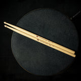 Meinl Kriss Rybalchenko Signature Drumsticks SB603 resting on a drum throne, ready for practice, rehearsal, or live performance.