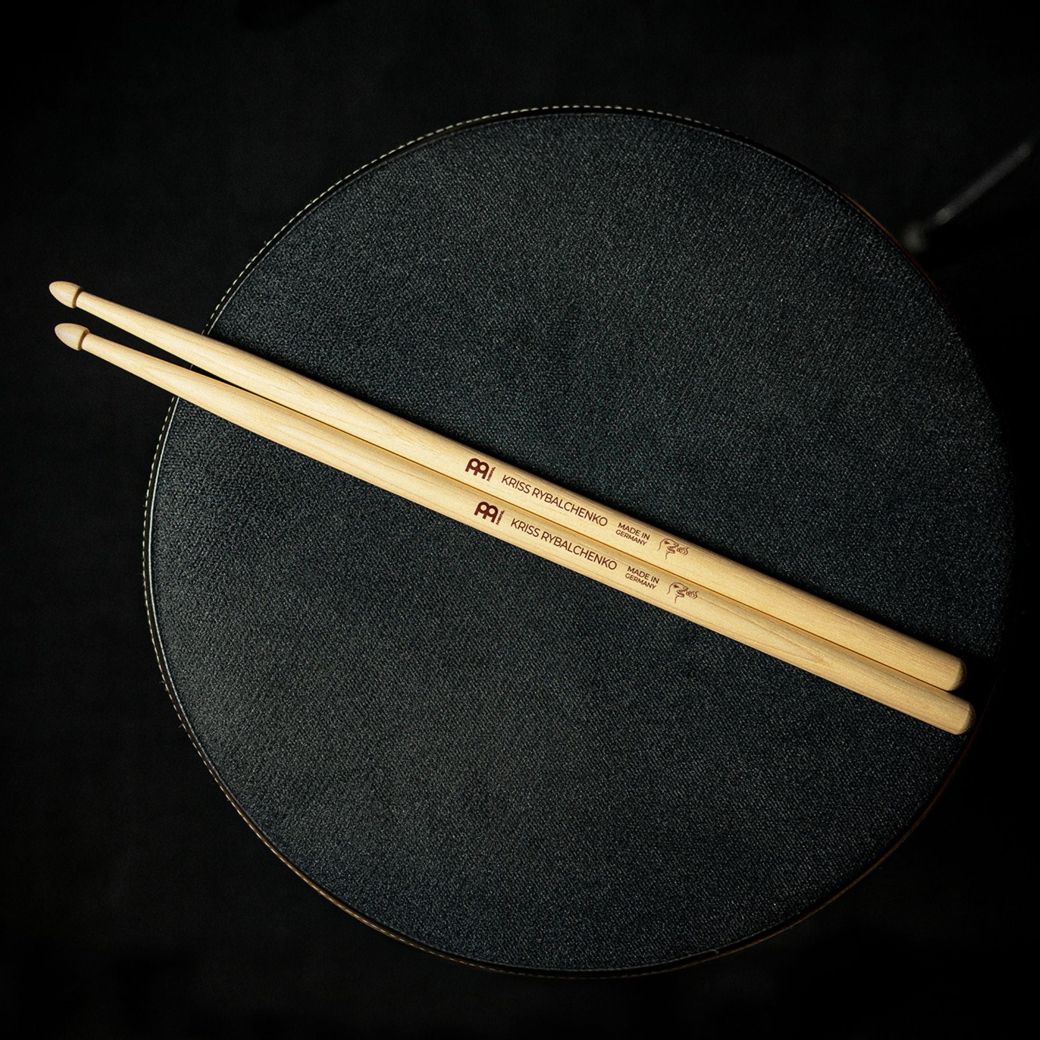 Meinl Kriss Rybalchenko Signature Drumsticks SB603 resting on a drum throne, ready for practice, rehearsal, or live performance.