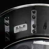 Close-up inside the Tama S.L.P. Black Brass Snare Drum LBR1465 showing the interior brass shell and snare-side hardware.