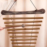 Close-up of the Meinl Sonic Energy Meditation Flow Chime 88cm 440Hz D Major Bronze MFC10DMAB being played by hand with the included mallet.