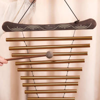 Close-up of the Meinl Sonic Energy Meditation Flow Chime 88cm 440Hz D Major Bronze MFC10DMAB being played by hand with the included mallet.