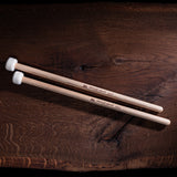 Aerial view of the Meinl 5A Drum Mallets SB401 with medium felt heads and American hickory handles displayed on a wooden surface.