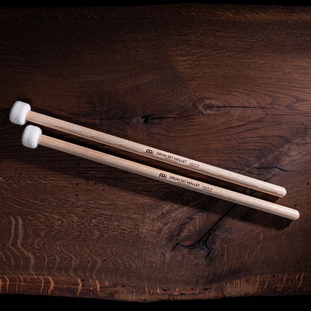 Aerial view of the Meinl 5A Drum Mallets SB401 with medium felt heads and American hickory handles displayed on a wooden surface.