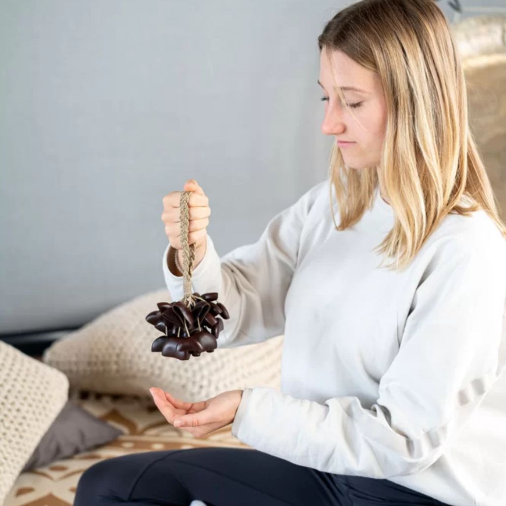 Woman holding the Meinl Sonic Energy Small Bendo Shaker SBRS by the wearable wrist strap.