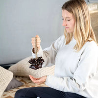 Woman holding the Meinl Sonic Energy Small Bendo Shaker SBRS by the wearable wrist strap.