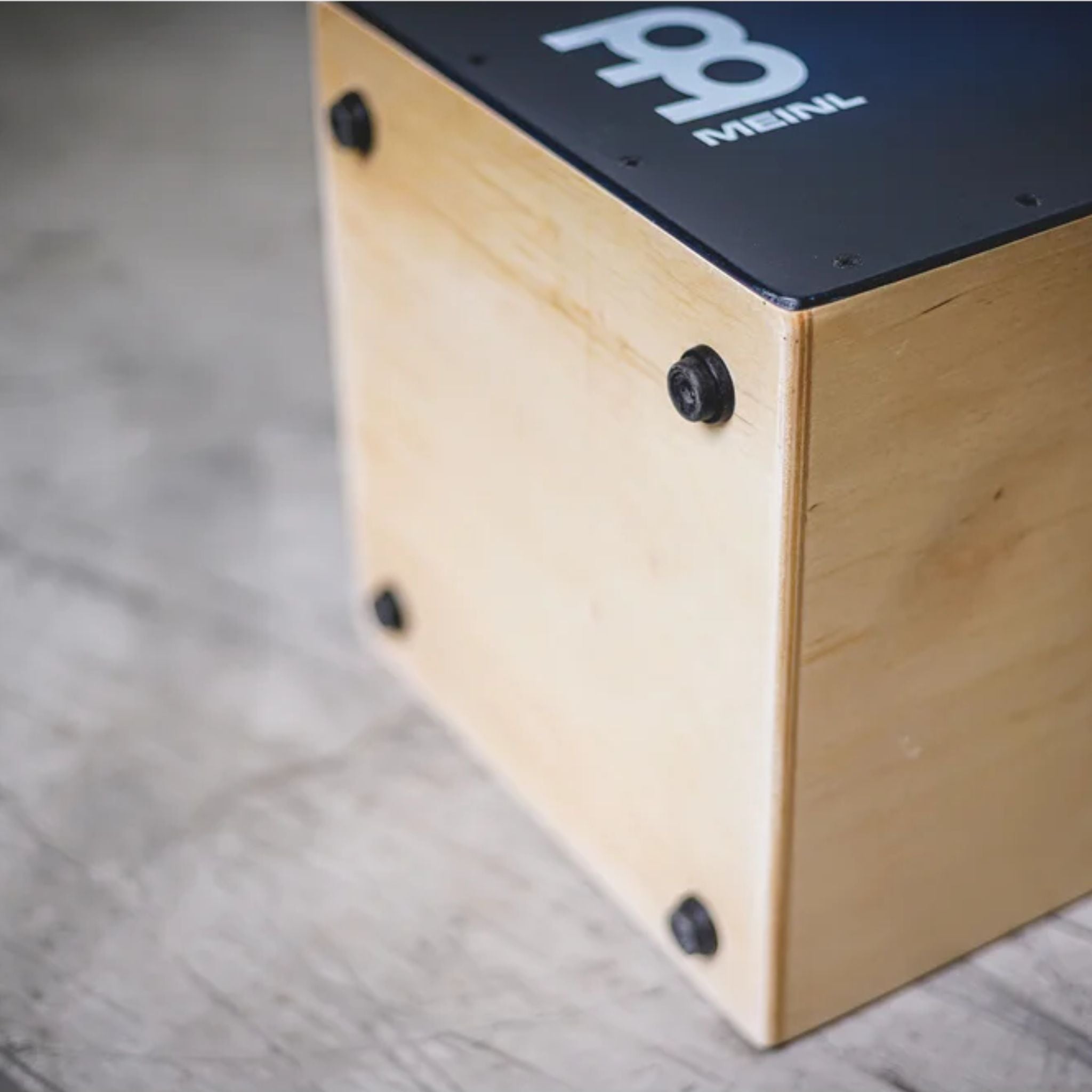 Bottom view showing rubber feet of the Meinl Snarecraft Cajon SC100BLB for stability and resonance.