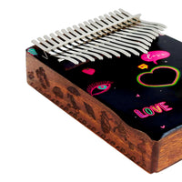 Close-up of the side of the Mahalo Kalimba Handmade Heart Design MKA17HE showing the handcrafted decorative artwork on the solid wood body.