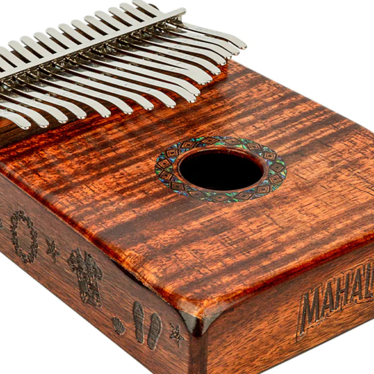 Close-up of the Mahalo Kalimba Thumb Piano Handmade Beach Scene MKA17KA showing the sound hole and Photo Flame Koa finish on the front of the instrument.