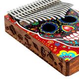 Close-up of the side of the Mahalo Kalimba Thumb Piano Handmade Day of the Dead Skull MKA17SK showing the handcrafted Day of the Dead Skull artwork on the solid wood body.