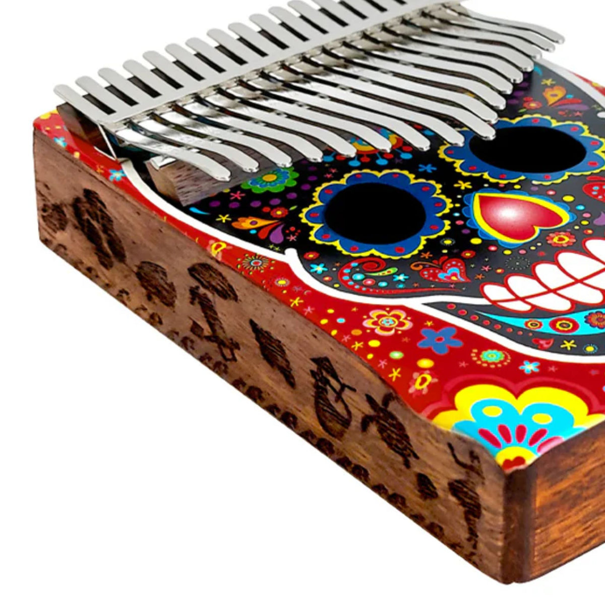 Close-up of the side of the Mahalo Kalimba Thumb Piano Handmade Day of the Dead Skull MKA17SK showing the handcrafted Day of the Dead Skull artwork on the solid wood body.