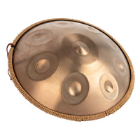 Angled view of the Mano Percussion ManoPan MPC69G 9-note D Kurd handpan showing its gold finish and curved profile.