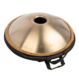 Bottom view of the Mano Percussion ManoPan MPC69G 9-note D Kurd handpan partially visible inside its open carry bag.