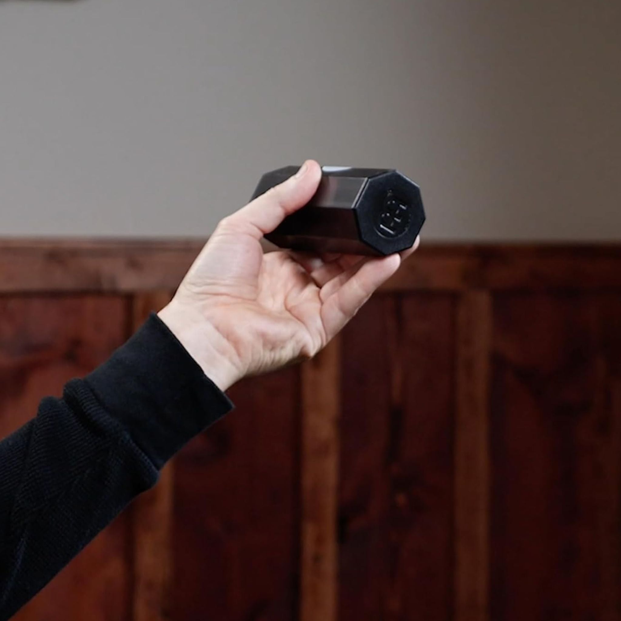 Handheld Meinl Aluminium Shaker Octagonal Small SH8BK in black, shown in a player’s hand to highlight compact size and ergonomic feel