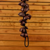 close up of lower section of Meinl Bendo Bird Shaker 40 Seeds BI5 showing natural Bendo seed nutshells with wooden background and handcrafted construction details