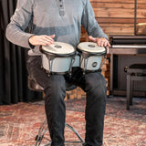 Meinl Journey Series bongo drums in Ultimate Gray (HB50UG), musician seated and playing the bongos in a studio setting.