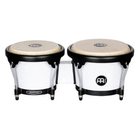 Meinl Journey Series bongo drums in white finish, compact paired bongos with natural drumheads and black hardware, front view on white background.