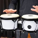Meinl Journey Series bongo drums in white finish, close-up of natural drumheads being played, highlighting response, feel, and compact performance design.