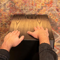Point-of-view shot of hands playing the Meinl Headliner Series Snare Cajon MCAJ100BK-CBF, showcasing responsive playing surface and precise articulation
