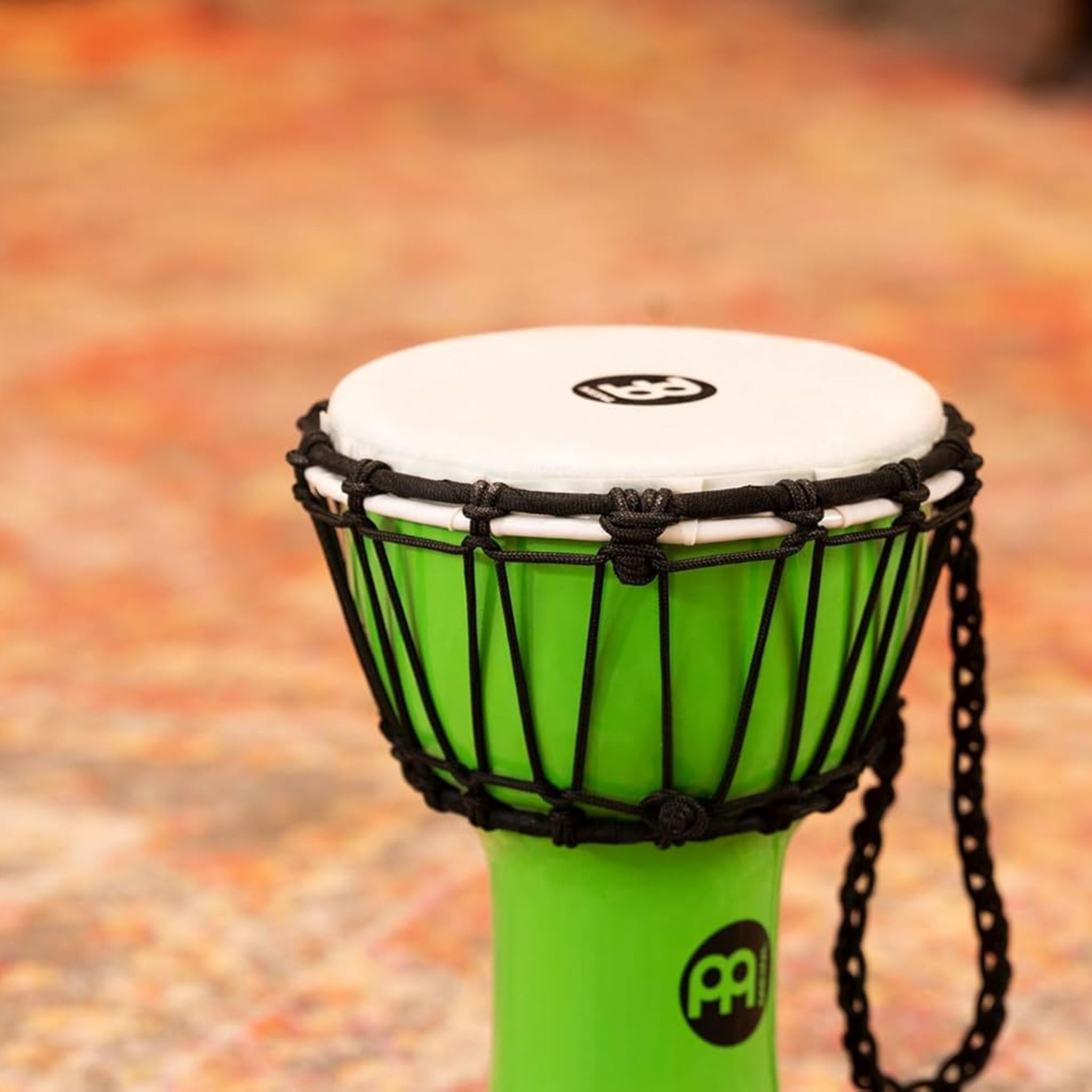 Side view of Meinl Junior Djembe Drum 7 inch Green JRD-G highlighting synthetic shell and rope system