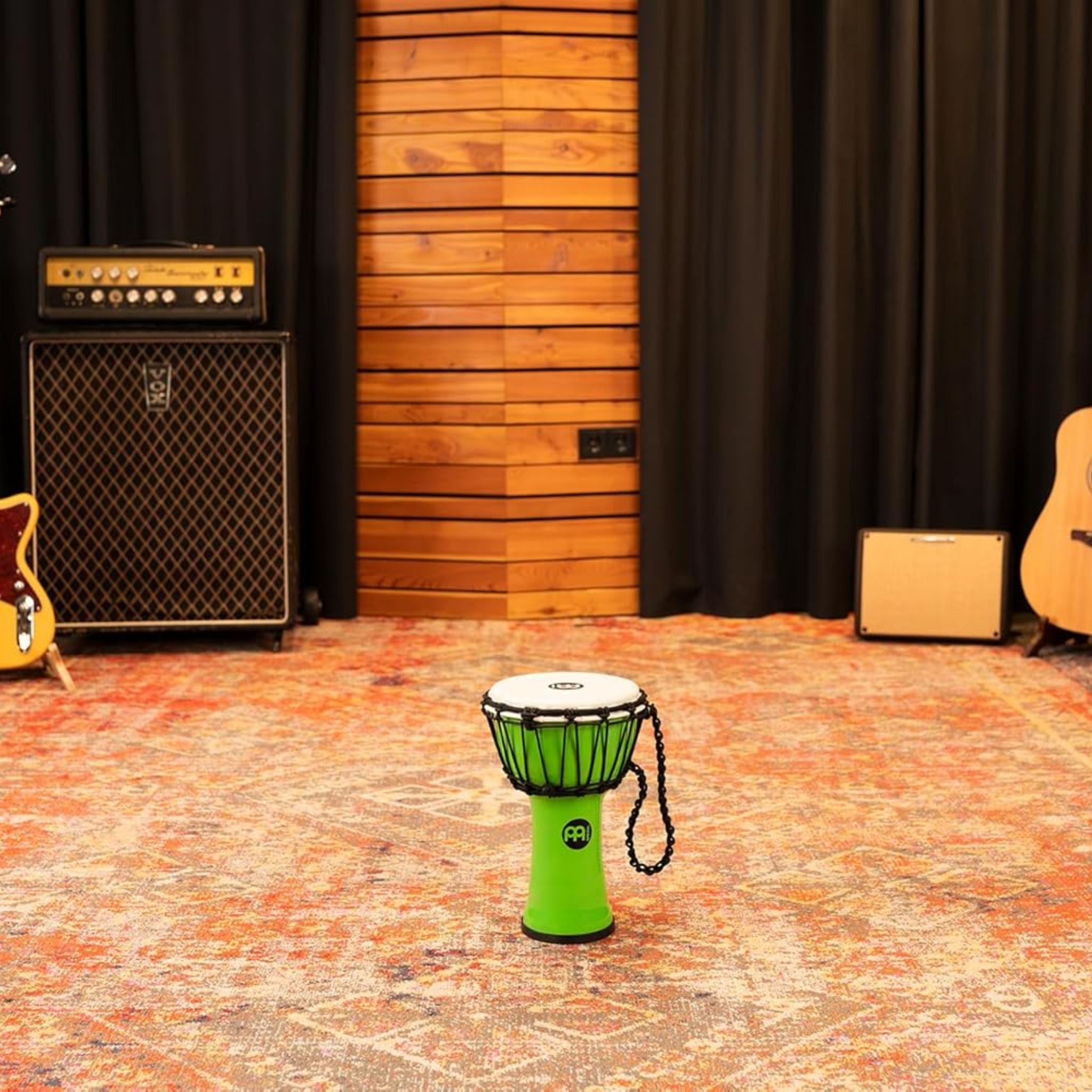 Meinl Junior Djembe Drum 7 inch Green JRD-G displayed in a professional music studio environment
