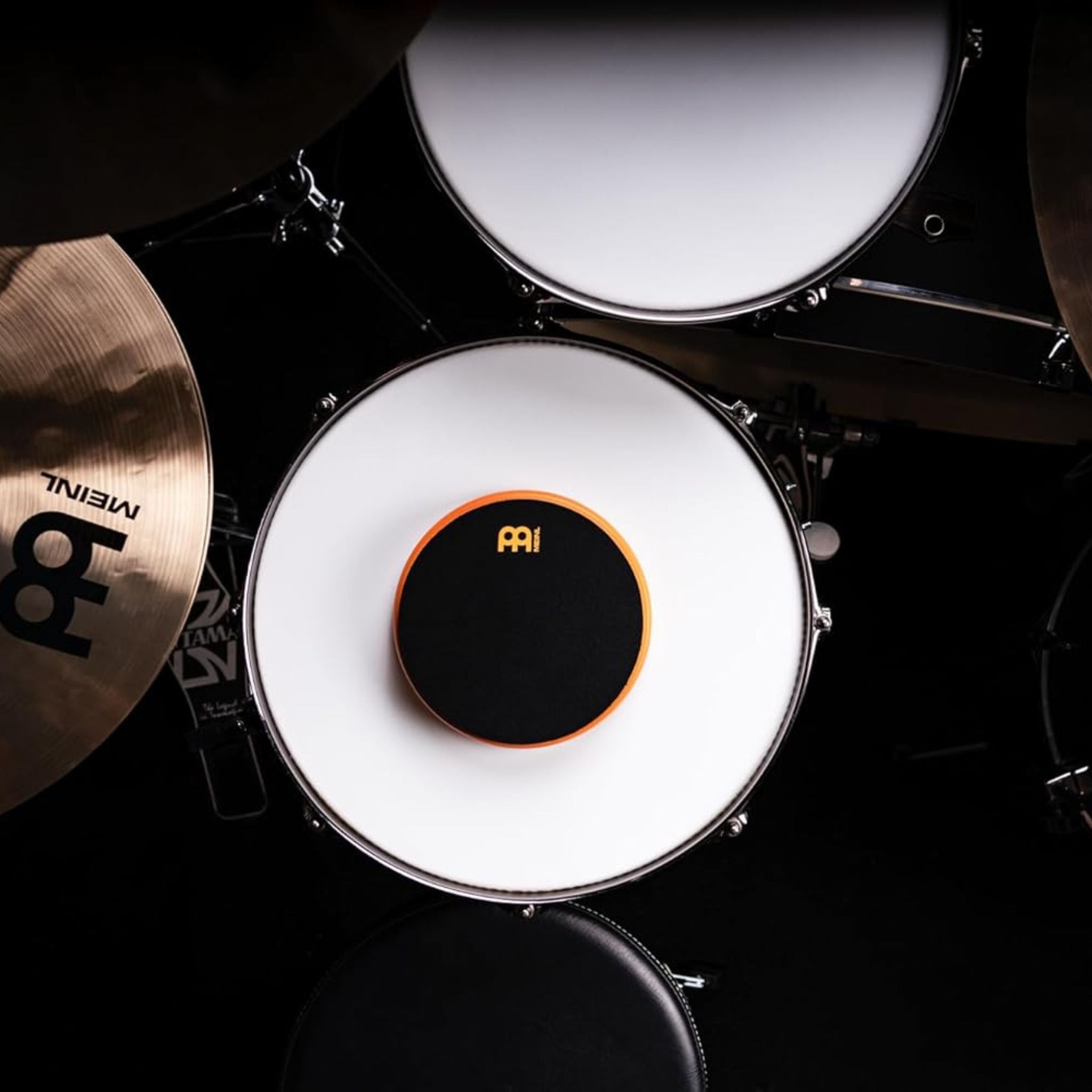 Meinl Marshmallow Practice Pad 6 inch Orange MMP6OR placed on snare drum within drum kit setup for quiet practice, stick control, and technique development