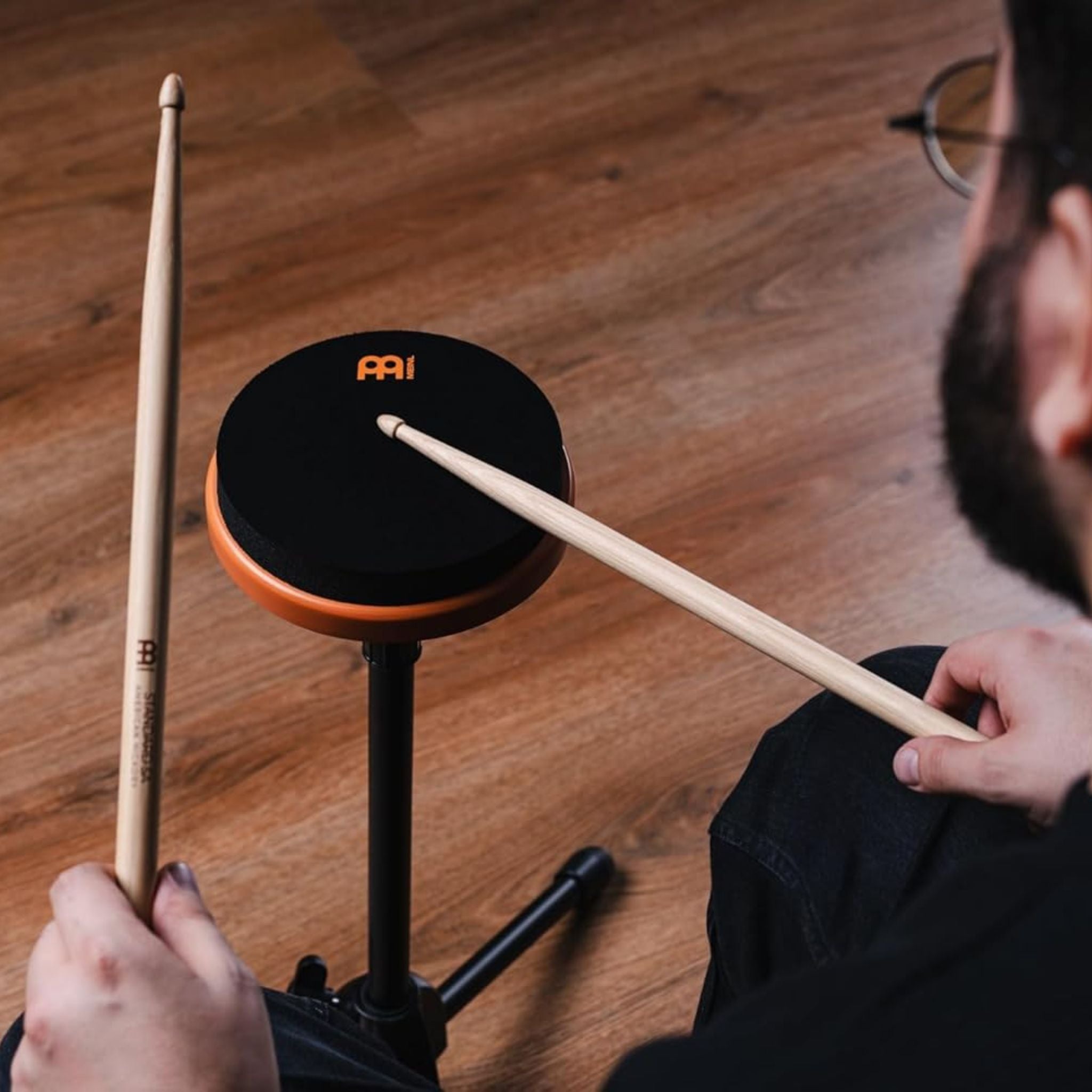 drummer playing Meinl Marshmallow Practice Pad 6 inch Orange MMP6OR mounted on stand for quiet practice, rudiments, and technique development