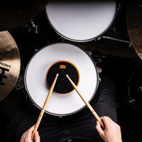 drummer playing Meinl Marshmallow Practice Pad 6 inch Orange MMP6OR on snare drum within drum kit setup for quiet practice, rudiments, stick control, and technique development