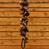 partial view of Meinl Pangi Waterfall Shaker 40 Seeds WA5 hanging vertically showing cascading natural Pangi seed nutshells and textured organic construction details