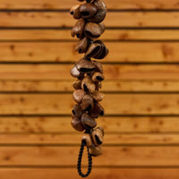 partial view of Meinl Pangi Waterfall Shaker 40 Seeds WA5 hanging vertically showing cascading natural Pangi seed nutshells and textured organic construction details
