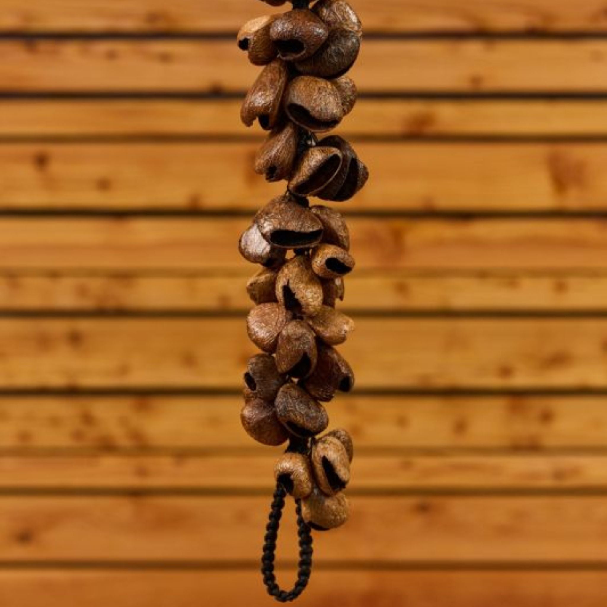 partial view of Meinl Pangi Waterfall Shaker 40 Seeds WA5 hanging vertically showing cascading natural Pangi seed nutshells and textured organic construction details