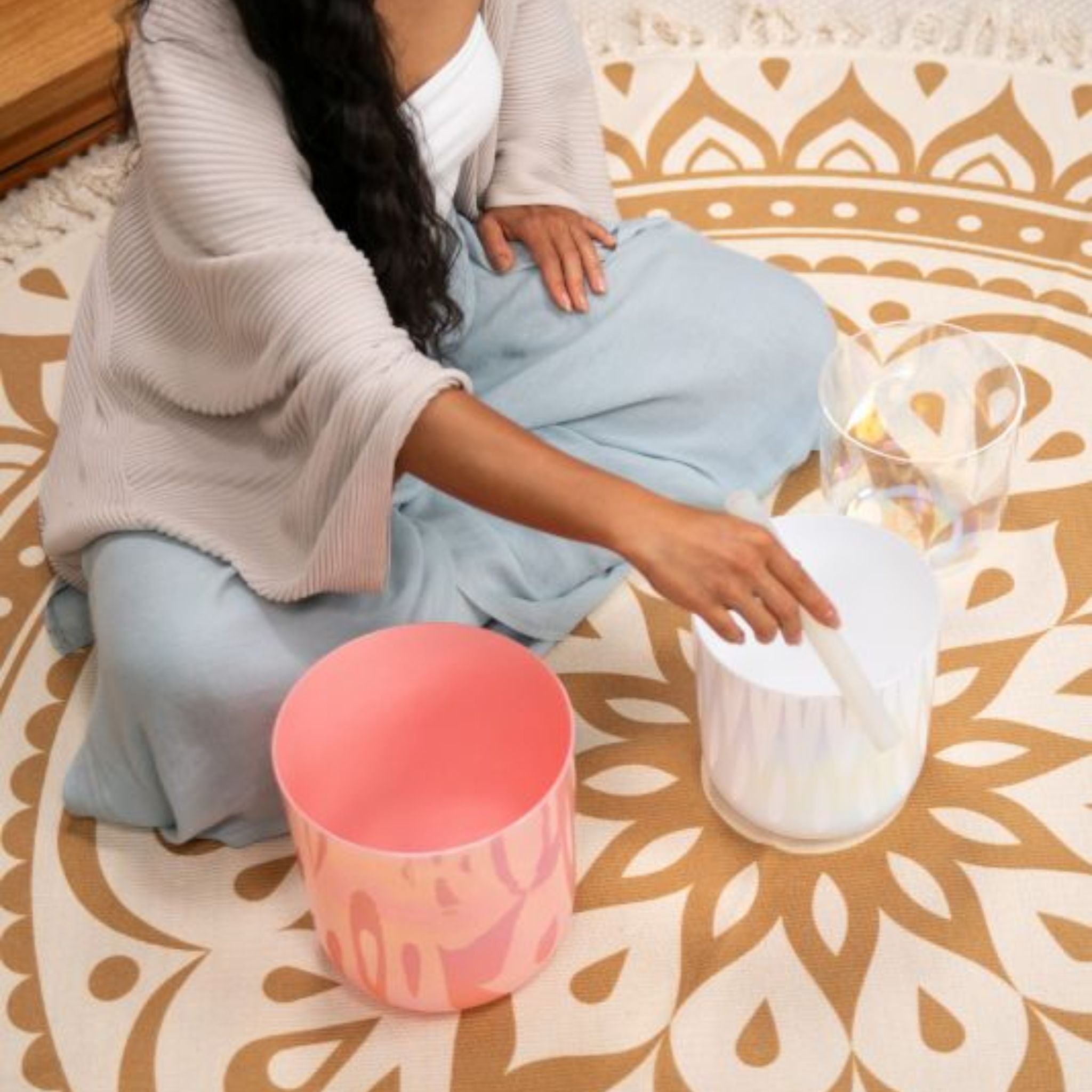 close up of woman playing the Meinl Sonic Energy 3-Piece Essence Crystal Singing Bowl Set E4 B3 G3 440Hz ECSBSETEBG showing crystal bowls, silicone rod technique, and rich resonant tones used for meditation, sound therapy, and mindfulness practice.