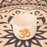 Meinl Sonic Energy 8 inch White Frosted Crystal Singing Bowl Om 136.10 Hz PCSB8OM resting on meditation rug showing high-purity quartz construction and white frosted finish for meditation, sound therapy, and immersive sound exploration