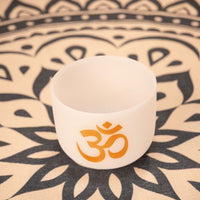 Meinl Sonic Energy 8 inch White Frosted Crystal Singing Bowl Om 136.10 Hz PCSB8OM resting on meditation rug showing high-purity quartz construction and white frosted finish for meditation, sound therapy, and immersive sound exploration