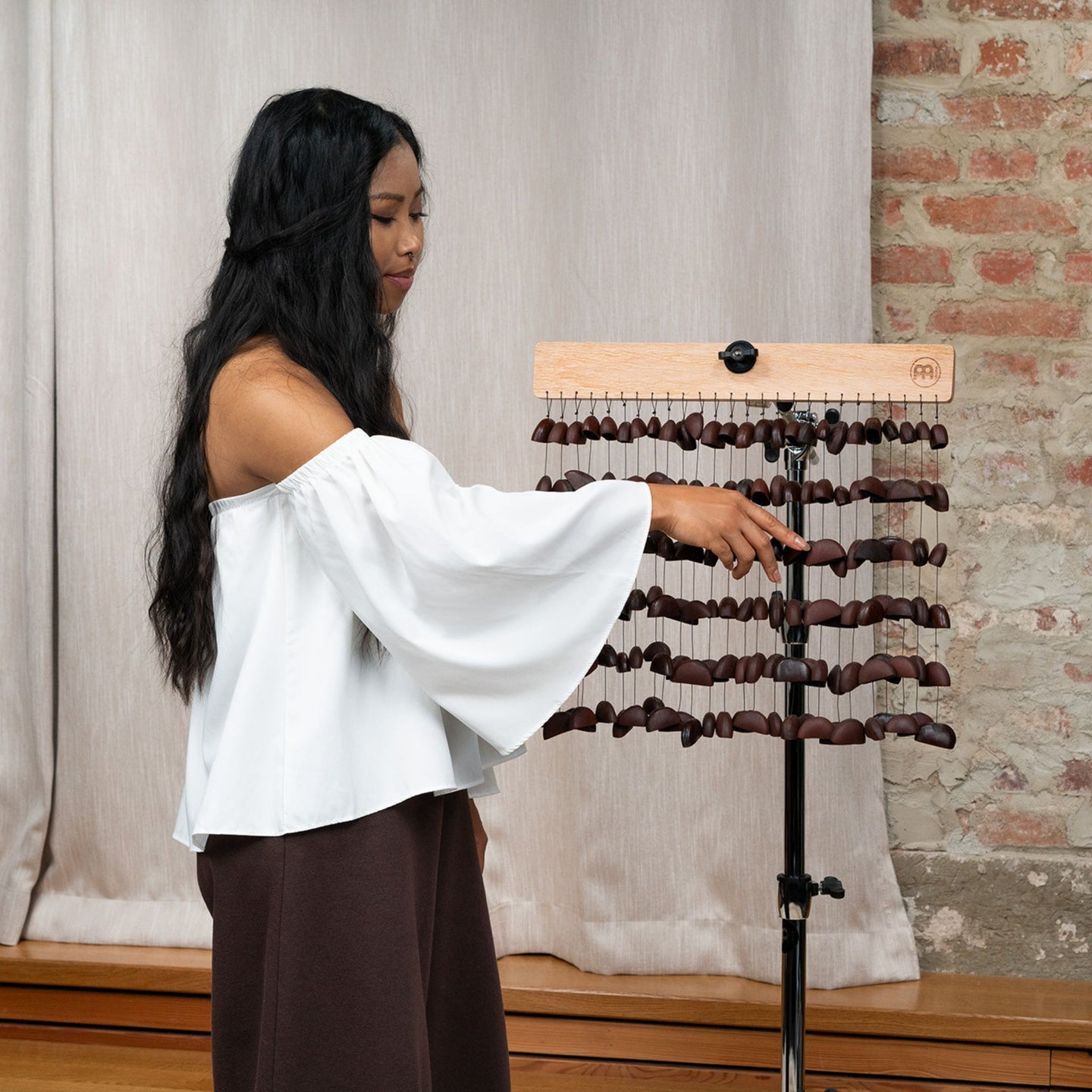 Woman playing Meinl Sonic Energy Bendo Chimes SBCH during a sound healing session for meditation and relaxation.
