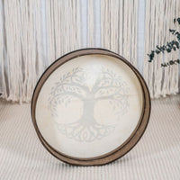 rear view of Meinl Sonic Energy Frame Drum 16 inch Tree of Life HD16WB-TOL resting on floor in calm setting showing Siam Oak frame construction and hand grip design