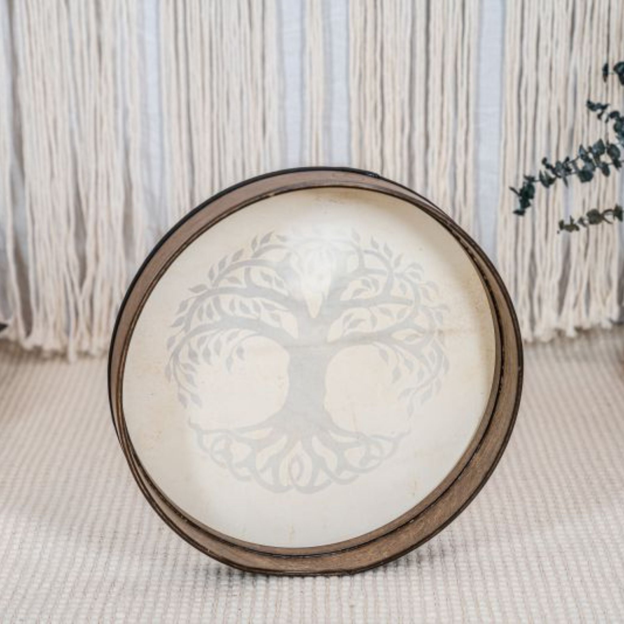 rear view of Meinl Sonic Energy Frame Drum 16 inch Tree of Life HD16WB-TOL resting on floor in calm setting showing Siam Oak frame construction and hand grip design