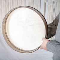 man holding Meinl Sonic Energy Frame Drum 16 inch Tree of Life HD16WB-TOL showing rear frame construction and comfortable hand grip design