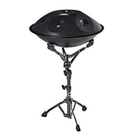 Meinl Sonic Energy handpan stand holding a compact black handpan, providing stable support and an ergonomic playing position for sound healing and performance.