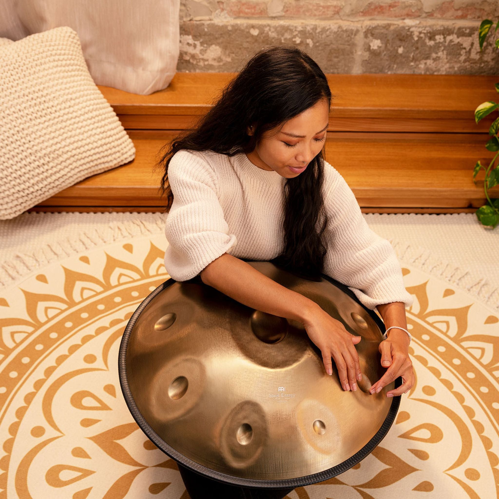Musician performing on the Meinl Sonic Energy Handpan, demonstrating its rich sustain and warm, resonant tone.