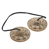 Meinl Sonic Energy TINGSHA-OR 3.15-inch tingshas featuring an ornamental design and connecting cord.