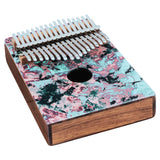 angled view of Meinl Sound Hole Designer Kalimba Coral Reef KA17CR showing the front edge, side profile, acacia wood construction, sound hole design, and 17-note layout on white background.